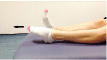 Person doing ankle stretching exercises by pointing and flexing their toes using a towel or bandage. (step 2)