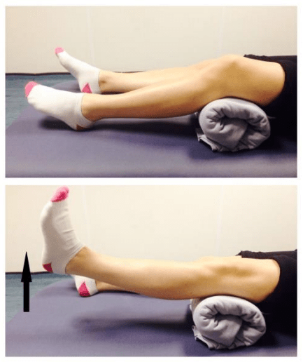 Person with a rolled up towel or small pillow underneath their injured knee doing inner quad exercises