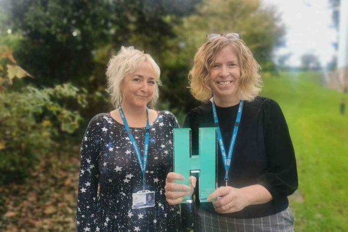 Claire Florey and Helen Williams holding the Health Technology News Digitising Patient Services Award 2022.