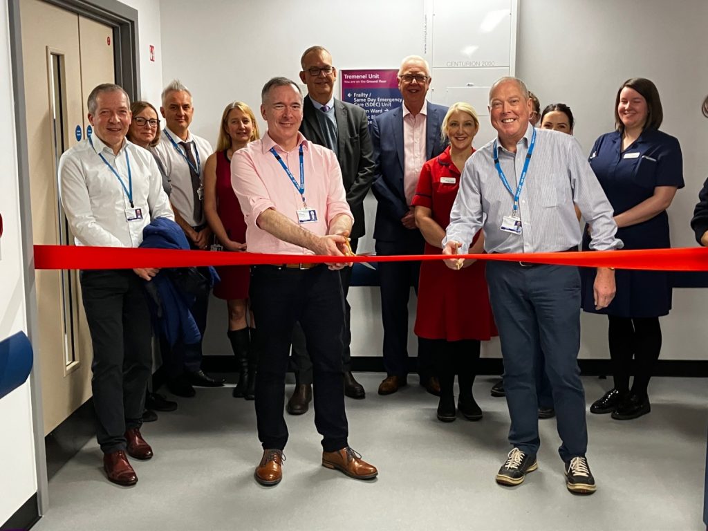 Photograph depicting Chief Executive Steve Williamson and Chief Financial Officer Karl Simkins cutting the ribbon at the official opening of RCHT's Tremenel Unit