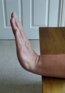 Person straightening their wrist upwards